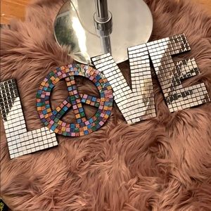 A mosaic piece of wall art “Peace & LOVE”
